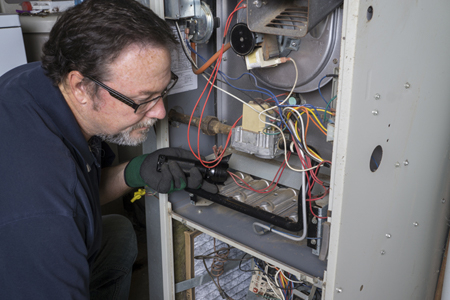 Repair man fixing Furnace